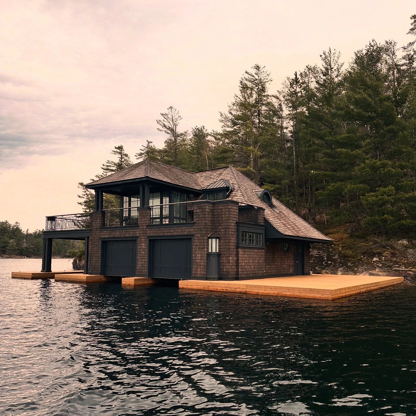 Finished boathouse with fresh timber dock at sunset