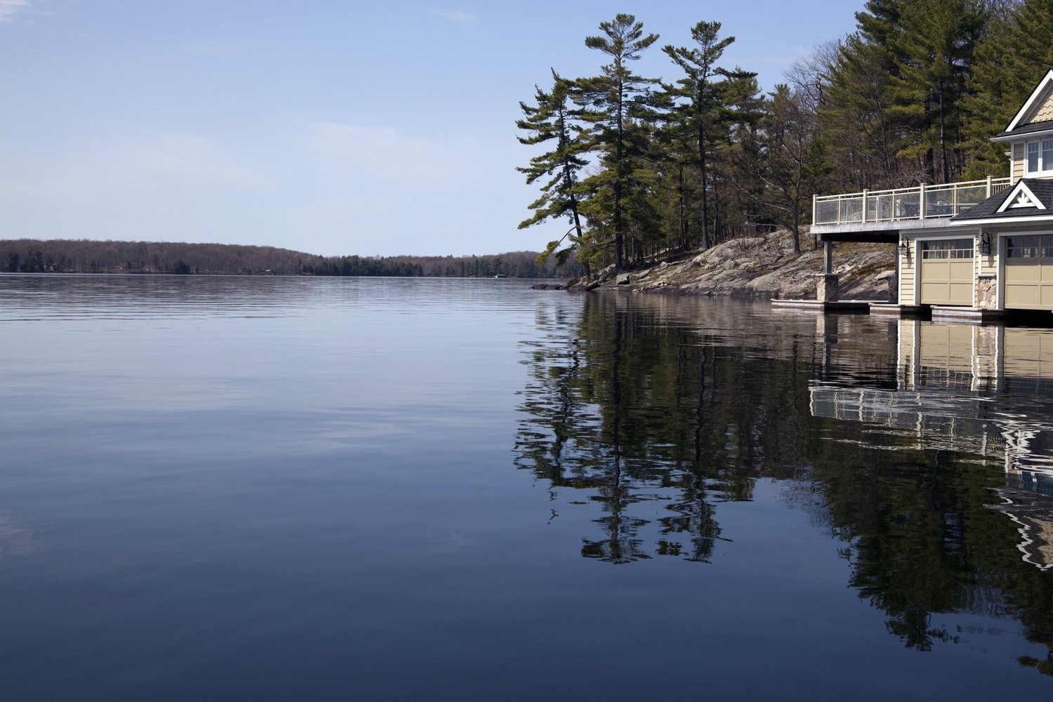 Still Muskoka water reflecting the shoreline