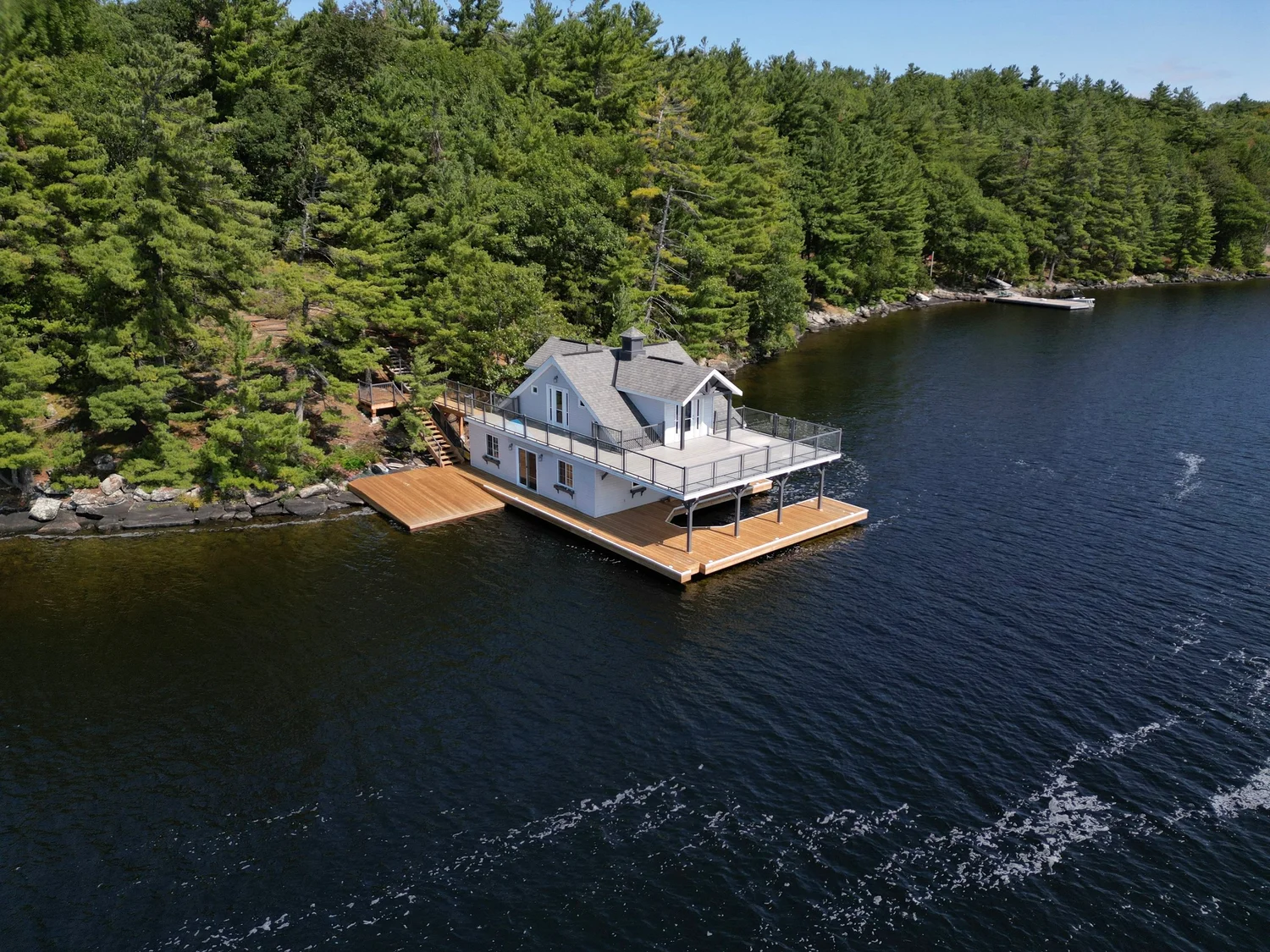 Boathouse and dock surrounded by Muskoka forest and water